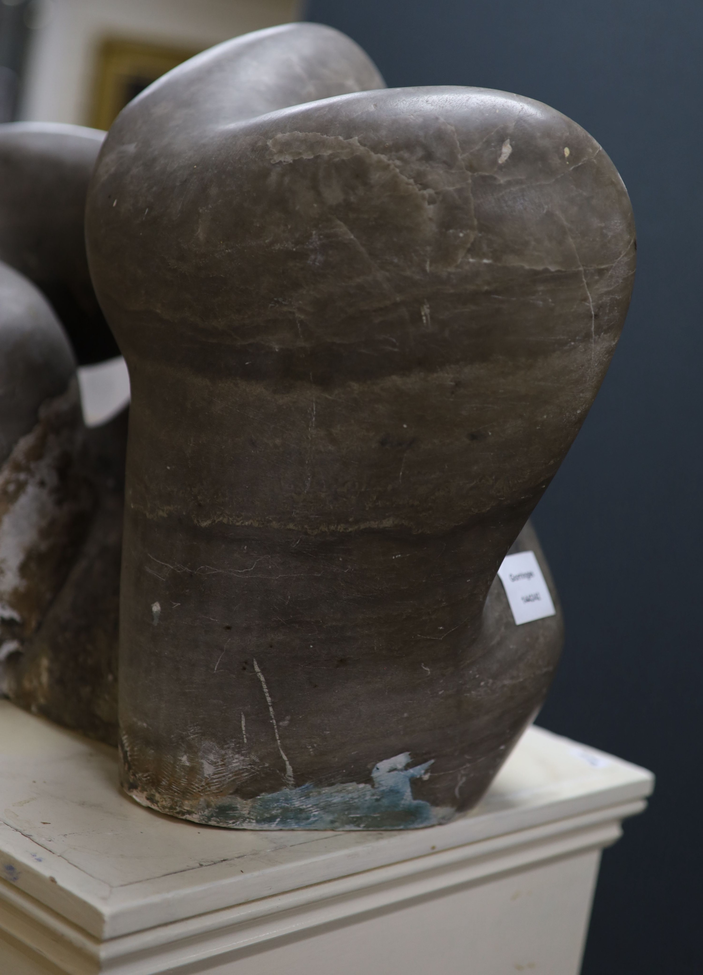 Wilby Hart, grey marble sculpture, abstract form, W 46cm. H 35cm. on a painted wood pedestal.
